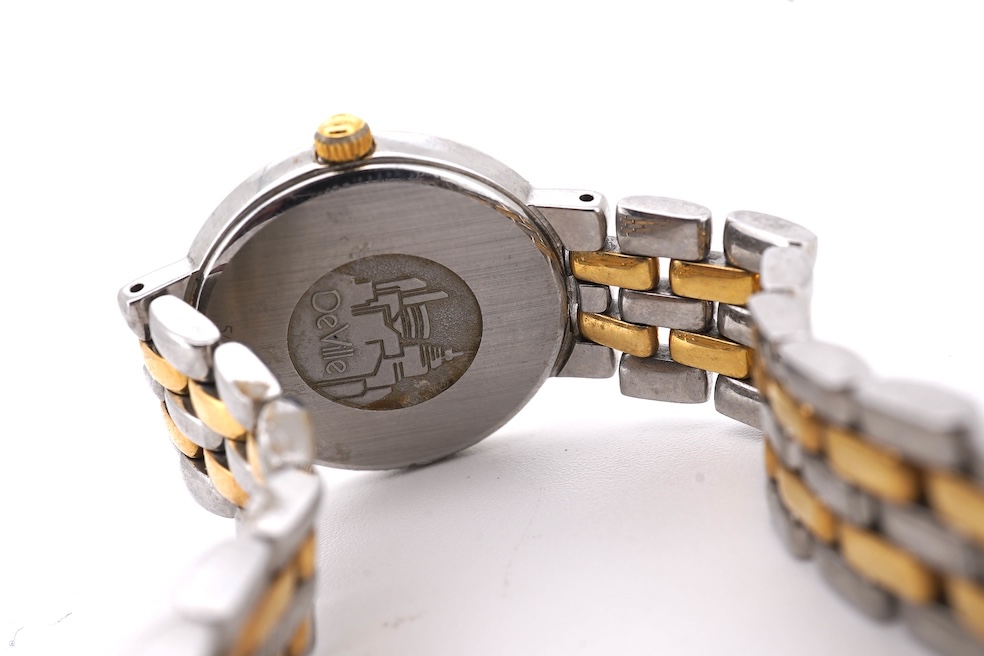 A lady's steel and gold plated Omega de Ville quartz wrist watch, with baton and quarterly Roman numerals, on a stainless steel and gold plated bracelet, case diameter 24mm, no box or papers. Condition - poor to fair